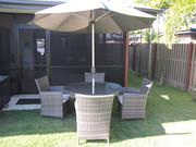 Outdoor wicker round table and four chairs plus sun umbrella.